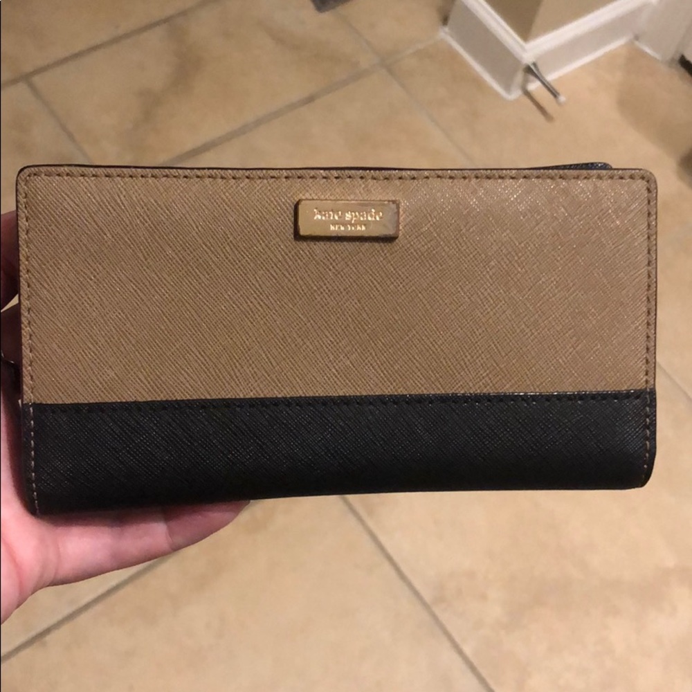 Tan/brown and black wallet with gold accent.